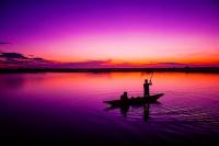 Fishing on a Lake at Sunset